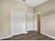 Bedroom featuring wood-look flooring, neutral walls, a closet, and view of another room at 2019 Wintermere Pointe Dr, Winter Garden, FL 34787