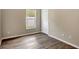 Bright bedroom featuring wood-look flooring, neutral walls, a window and a closet at 2019 Wintermere Pointe Dr, Winter Garden, FL 34787