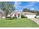 Charming one-story home with a well-manicured lawn, red trim, and an attached two-car garage at 2019 Wintermere Pointe Dr, Winter Garden, FL 34787