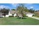 Charming home with a lush front yard and mature trees, exuding curb appeal at 2019 Wintermere Pointe Dr, Winter Garden, FL 34787