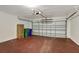 Spacious garage with painted floor, white brick walls, and an automatic garage door opener at 2019 Wintermere Pointe Dr, Winter Garden, FL 34787