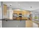 Modern kitchen with granite countertops, stainless steel appliances, and light wood cabinets at 2019 Wintermere Pointe Dr, Winter Garden, FL 34787