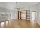 Living room featuring french doors, hardwood floors, ceiling fan, and wooden bookcase at 2019 Wintermere Pointe Dr, Winter Garden, FL 34787