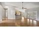 Open-concept living area with wood floors, kitchen views, and access to the screened in pool at 2019 Wintermere Pointe Dr, Winter Garden, FL 34787