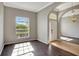Sunlit living room featuring wood floors, large windows, and neutral paint at 2019 Wintermere Pointe Dr, Winter Garden, FL 34787