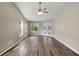 Bright living room featuring vaulted ceilings, wood-look floors, windows, and French doors at 2019 Wintermere Pointe Dr, Winter Garden, FL 34787