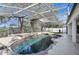 Private screened-in pool area with rock waterfall feature and mature landscaping at 2019 Wintermere Pointe Dr, Winter Garden, FL 34787