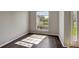 Neutral room featuring dark wood flooring and natural light from the windows at 2019 Wintermere Pointe Dr, Winter Garden, FL 34787