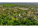 Scenic aerial view of the neighborhood, showcasing lush greenery and a tranquil pond nearby at 2049 Eldorado Ct, St Cloud, FL 34771