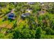 Aerial view of a home with a sprawling, fenced backyard, mature trees, and a convenient storage shed at 2049 Eldorado Ct, St Cloud, FL 34771