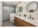 Bright bathroom with a double vanity, quartz countertop, and a glass-enclosed shower at 2049 Eldorado Ct, St Cloud, FL 34771