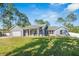 Charming single-story home featuring a well-manicured lawn and an attached two car garage at 2049 Eldorado Ct, St Cloud, FL 34771