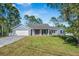 Charming single-story home features a blue exterior, well-manicured lawn, and an attached two-car garage at 2049 Eldorado Ct, St Cloud, FL 34771