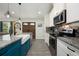 Bright kitchen featuring white cabinets, granite countertops, stainless steel appliances, and an oversized farmhouse sink at 2049 Eldorado Ct, St Cloud, FL 34771