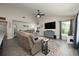Bright living room with large windows, comfortable seating, and a view of the adjacent dining and recreational areas at 2049 Eldorado Ct, St Cloud, FL 34771