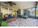 Inviting covered patio with stylish wicker furniture and a ceiling fan for comfortable outdoor living at 2049 Eldorado Ct, St Cloud, FL 34771