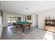 Recreation room featuring a pool table, stylish decor, and sliding glass doors leading to an outdoor area at 2049 Eldorado Ct, St Cloud, FL 34771