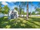 Durable backyard shed for extra storage, surrounded by mature trees and a well-maintained lawn at 2049 Eldorado Ct, St Cloud, FL 34771