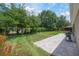 Landscaped backyard with a brick patio, lush green grass, a garden, and a privacy fence at 217 Victoria Trails Blvd, Deland, FL 32724