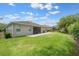 Well-maintained backyard with a patio area, lush green lawn, and mature trees at 217 Victoria Trails Blvd, Deland, FL 32724