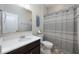 Neutral-toned bathroom with a large mirror, shower with curtain, and a vanity with a white countertop at 217 Victoria Trails Blvd, Deland, FL 32724