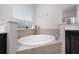 Bright bathroom showcasing soaking tub by a window, offering a serene space for relaxation at 217 Victoria Trails Blvd, Deland, FL 32724