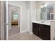Tastefully designed bathroom showcasing vanity with a marble countertop, open to the bedroom, creating a harmonious space at 217 Victoria Trails Blvd, Deland, FL 32724