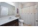 Well-maintained bathroom with a modern vanity, toilet, and shower with curtain, offering essential functionality at 217 Victoria Trails Blvd, Deland, FL 32724