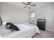 Chic bedroom features a comfortable bed, dresser, and a ceiling fan, providing a relaxing and stylish atmosphere at 217 Victoria Trails Blvd, Deland, FL 32724