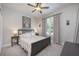 Cozy bedroom with neutral tones, featuring ceiling fan, a plush bed, and ample natural light, creating a tranquil retreat at 217 Victoria Trails Blvd, Deland, FL 32724