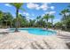 Inviting community pool with palm trees, lounge chairs, and a beautiful blue sky at 217 Victoria Trails Blvd, Deland, FL 32724