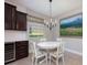 Bright dining area features modern chandelier, mountain view art and a wine cooler, perfect for entertaining at 217 Victoria Trails Blvd, Deland, FL 32724