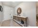 Bright foyer showcasing decorative table and mirror, with the front door offering natural light at 217 Victoria Trails Blvd, Deland, FL 32724