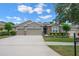 Charming single-story home featuring a manicured lawn, stone accents, and a two-car garage at 217 Victoria Trails Blvd, Deland, FL 32724
