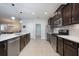 Modern kitchen featuring stainless steel appliances, dark wood cabinets, and a kitchen island at 217 Victoria Trails Blvd, Deland, FL 32724