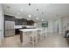Bright kitchen with stainless steel appliances, dark cabinets, and a kitchen island with bar seating at 217 Victoria Trails Blvd, Deland, FL 32724