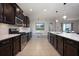 Spacious kitchen with stainless steel appliances, dark cabinets, and a breakfast nook at 217 Victoria Trails Blvd, Deland, FL 32724