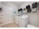A laundry room with a side-by-side washer and dryer and open shelving for storage and organization at 217 Victoria Trails Blvd, Deland, FL 32724