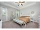Relaxing bedroom featuring tray ceiling, ceiling fan, and bench seating, perfect for unwinding after a long day at 217 Victoria Trails Blvd, Deland, FL 32724