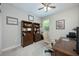 Bright office with natural light, ceiling fan, built-in bookshelves, and a comfortable executive-style chair at 217 Victoria Trails Blvd, Deland, FL 32724