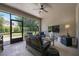Covered screened patio featuring comfortable wicker furniture and a ceiling fan for relaxed outdoor living at 217 Victoria Trails Blvd, Deland, FL 32724