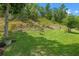 Lush backyard featuring mature trees, manicured grass, and landscaping at 2217 Caledonian St, Clermont, FL 34711