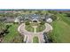 Expansive aerial view of the clubhouse, with manicured landscaping and palm trees surrounding the circle driveway at 2217 Caledonian St, Clermont, FL 34711