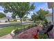 Charming front yard with brick patio, complemented by lush greenery, flowerpots, and mature trees at 2217 Caledonian St, Clermont, FL 34711
