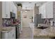 Modern kitchen with white cabinets, stainless steel appliances, and granite countertops at 2217 Caledonian St, Clermont, FL 34711