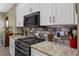 Updated kitchen showcases granite countertops, stainless steel appliances, and modern cabinetry at 2217 Caledonian St, Clermont, FL 34711