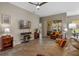 Cozy living room with neutral tones, tile flooring, and sliding glass doors to the patio at 2217 Caledonian St, Clermont, FL 34711