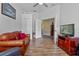 Spacious living room featuring wood floors, and a view into the kitchen and hallway at 2217 Caledonian St, Clermont, FL 34711