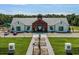 Aerial view of the community center showing the manicured lawn, common area and adjacent parking area for residents at 2897 Elio Hammock Dr, St Cloud, FL 34773
