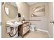 Charming half bathroom featuring decorative vanity, modern sink, with stylish light fixtures and neutral wall color at 2897 Elio Hammock Dr, St Cloud, FL 34773